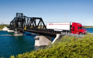 White and Red truck crossing bridge