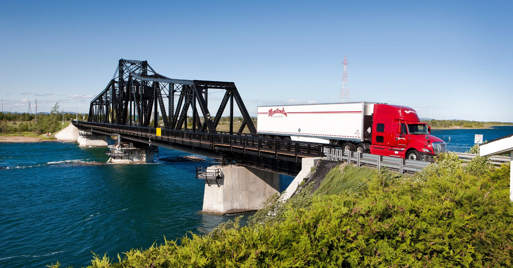 White and Red truck crossing bridge